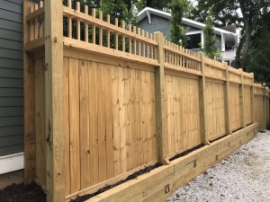 Vertical Lockboard Privacy Fence with Decorative Picket Top Rail